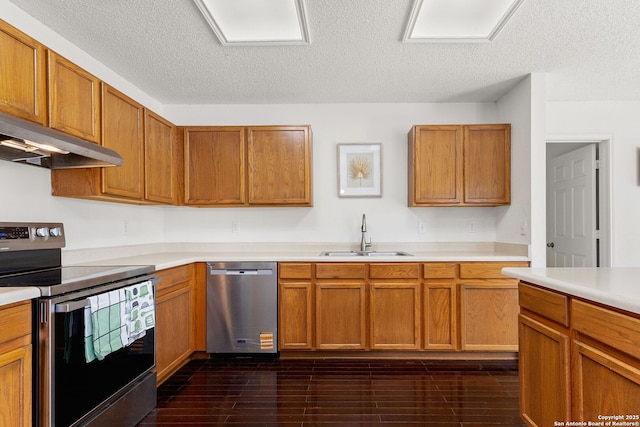 1339 Pecan Sta, San Antonio, TX 78258 - kitchen with appliances with stainless steel finishes, a sink, light countertops, under cabinet range hood, and a textured ceiling