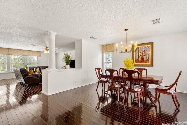 1339 Pecan Sta, San Antonio, TX 78258 - dining room featuring decorative columns, a textured ceiling, healthy amount of natural light, hardwood / wood-style flooring, and baseboards