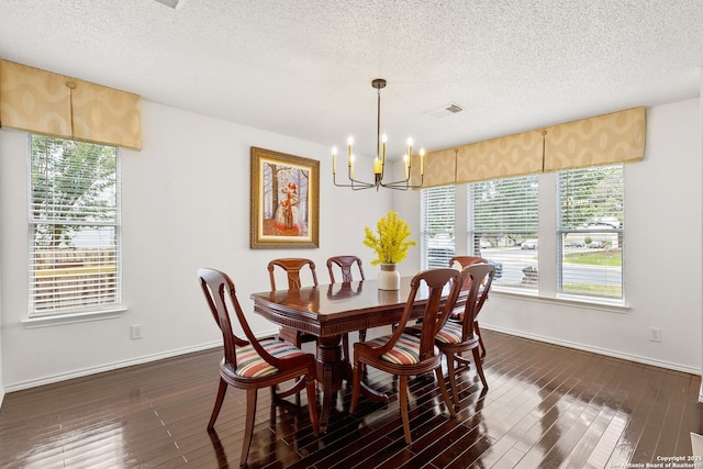 1339 Pecan Sta, San Antonio, TX 78258 - dining area featuring a chandelier, a textured ceiling, dark wood-style flooring, and baseboards