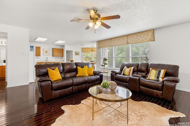 1339 Pecan Sta, San Antonio, TX 78258 - living area with dark wood-style floors, ceiling fan, a textured ceiling, and baseboards