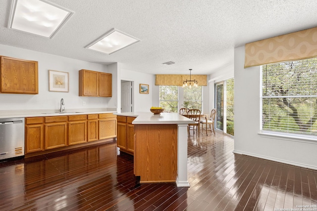 1339 Pecan Sta, San Antonio, TX 78258 - kitchen with a sink, stainless steel dishwasher, a textured ceiling, light countertops, and a chandelier