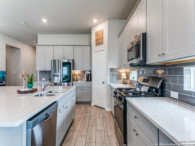 5344 Jasmine, Bulverde, TX 78163 - kitchen with stainless steel appliances, a sink, tasteful backsplash, light stone countertops, and recessed lighting