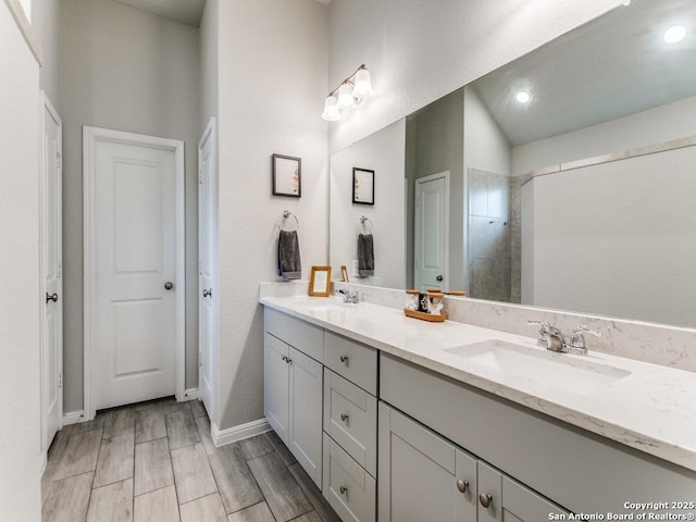 5344 Jasmine, Bulverde, TX 78163 - bathroom featuring double vanity, baseboards, recessed lighting, and wood finished floors