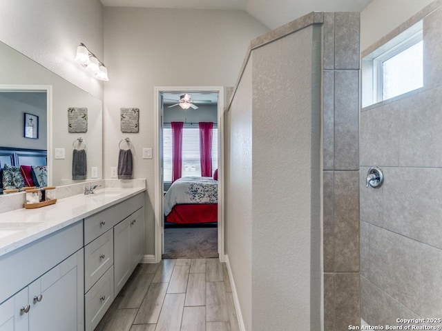 5344 Jasmine, Bulverde, TX 78163 - full bathroom featuring connected bathroom, double vanity, tiled shower, ceiling fan, and wood finish floors