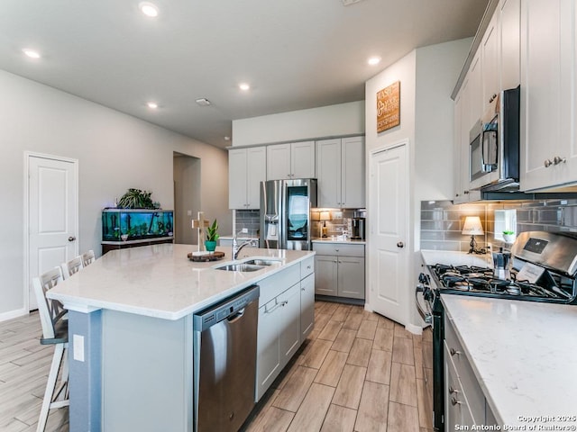 5344 Jasmine, Bulverde, TX 78163 - kitchen with stainless steel appliances, a sink, wood tiled floors, backsplash, and recessed lighting