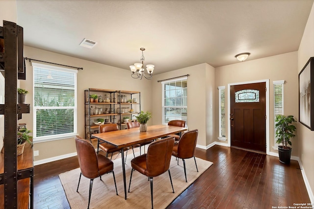 267 Oak Crk, New Braunfels, TX 78130 - dining area featuring baseboards, a chandelier, plenty of natural light, and dark wood-style flooring