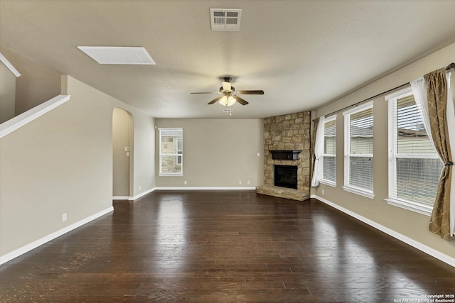 267 Oak Crk, New Braunfels, TX 78130 - unfurnished living room with ceiling fan, arched walkways, plenty of natural light, and a fireplace
