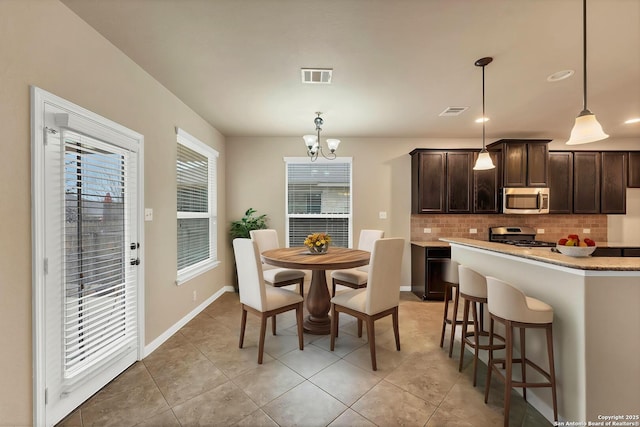267 Oak Crk, New Braunfels, TX 78130 - dining area featuring a chandelier, light tile patterned flooring, and baseboards