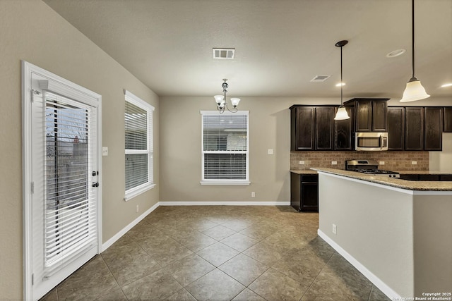 267 Oak Crk, New Braunfels, TX 78130 - kitchen with appliances with stainless steel finishes, tasteful backsplash, dark brown cabinetry, tile patterned floors, and decorative light fixtures