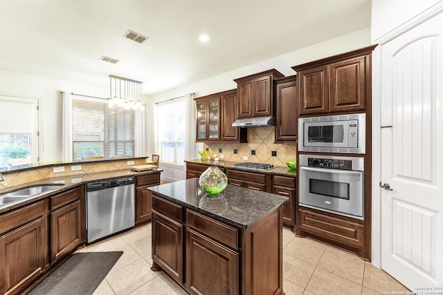 25702 Willard Path, San Antonio, TX 78261 - kitchen featuring stainless steel appliances, under cabinet range hood, tasteful backsplash, light tile patterned floors, and recessed lighting