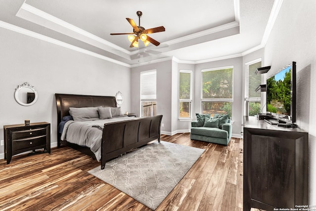 25702 Willard Path, San Antonio, TX 78261 - bedroom featuring a tray ceiling, hardwood / wood-style floors, crown molding, baseboards, and ceiling fan