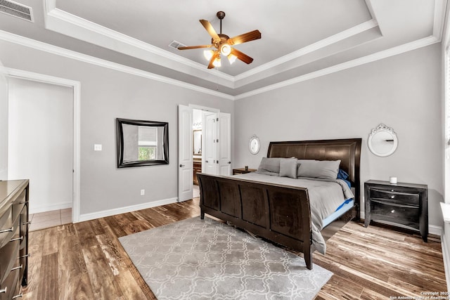 25702 Willard Path, San Antonio, TX 78261 - bedroom with a raised ceiling, wood finished floors, baseboards, crown molding, and a ceiling fan