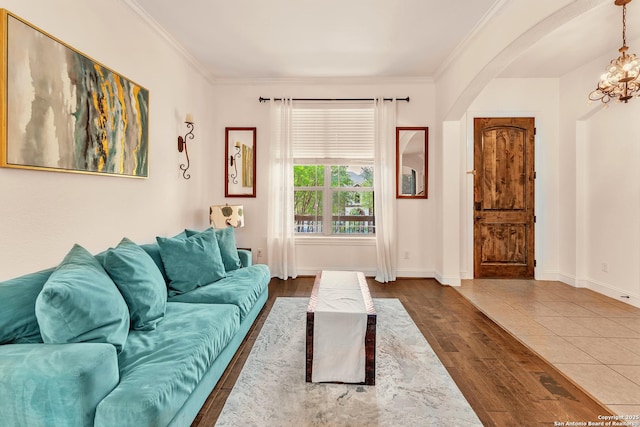 25702 Willard Path, San Antonio, TX 78261 - living room featuring arched walkways, a chandelier, wood finished floors, crown molding, and baseboards