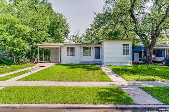 135 Englewood, San Antonio, TX 78213 - view of front facade featuring driveway, a front lawn, board and batten siding, and an attached carport
