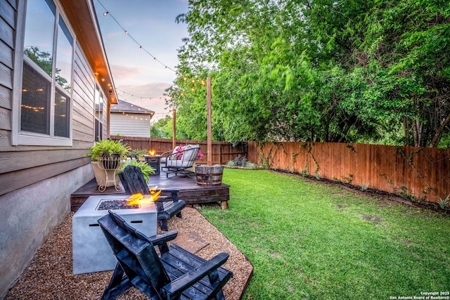 891 Noel, New Braunfels, TX 78130 - yard at dusk with a fire pit and a wooden deck