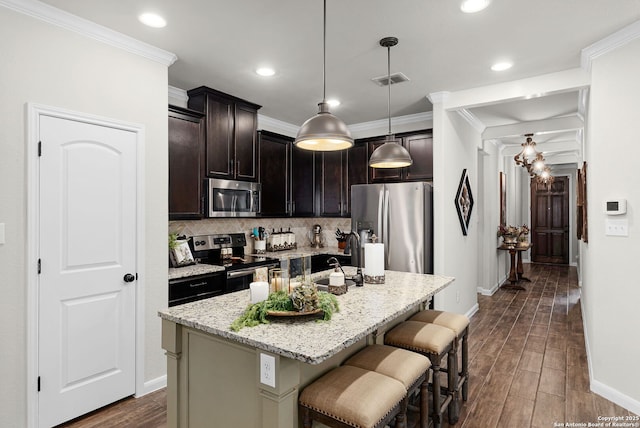 891 Noel, New Braunfels, TX 78130 - kitchen with appliances with stainless steel finishes, baseboards, a breakfast bar area, light stone counters, and tasteful backsplash