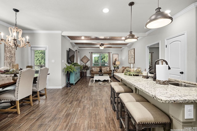 891 Noel, New Braunfels, TX 78130 - dining space featuring a chandelier, dark wood-style flooring, crown molding, baseboards, and beamed ceiling