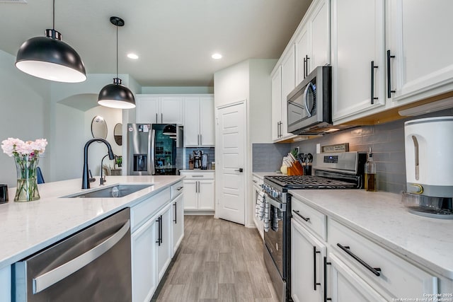 2103 Dalhart, San Antonio, TX 78253 - kitchen featuring a sink, stainless steel appliances, white cabinetry, light wood finished floors, and recessed lighting