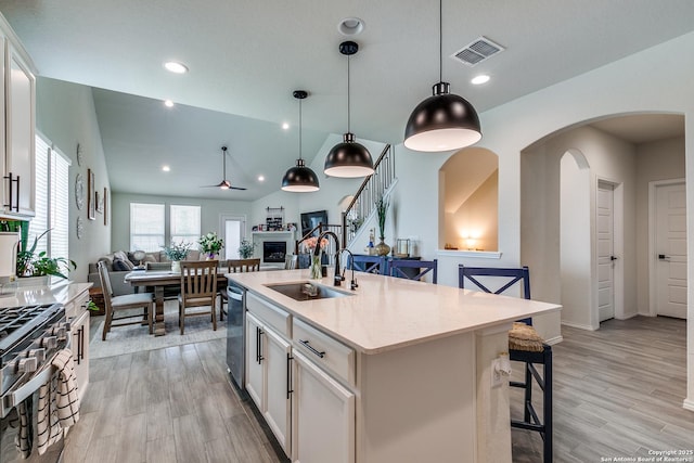 2103 Dalhart, San Antonio, TX 78253 - kitchen featuring open floor plan, a sink, stainless steel appliances, arched walkways, and light wood-type flooring