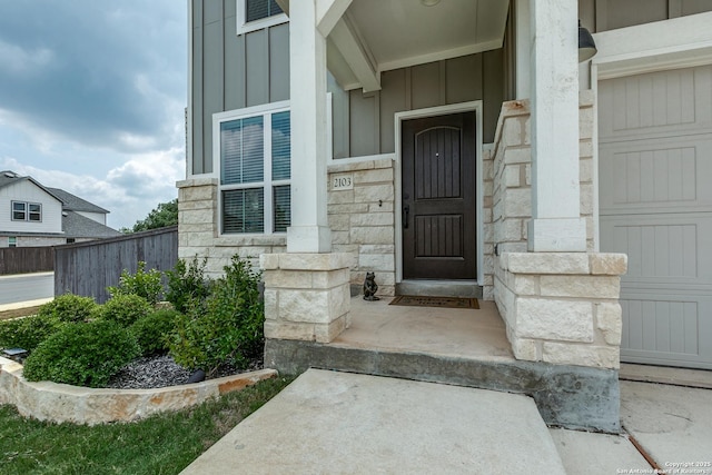 2103 Dalhart, San Antonio, TX 78253 - view of exterior entry with board and batten siding, stone siding, and a garage