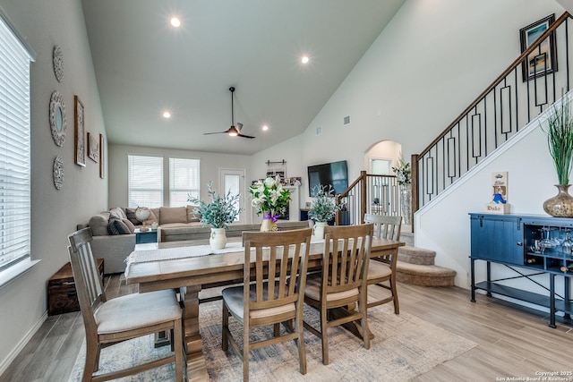 2103 Dalhart, San Antonio, TX 78253 - dining area featuring stairway, arched walkways, ceiling fan, high vaulted ceiling, and light wood-style flooring