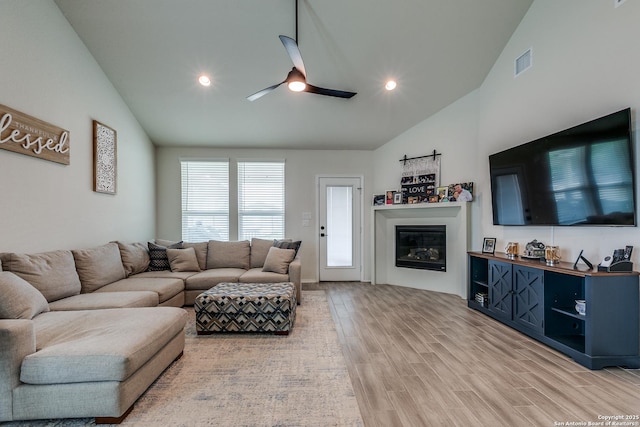 2103 Dalhart, San Antonio, TX 78253 - living room featuring lofted ceiling, ceiling fan, light wood-style flooring, a glass covered fireplace, and recessed lighting