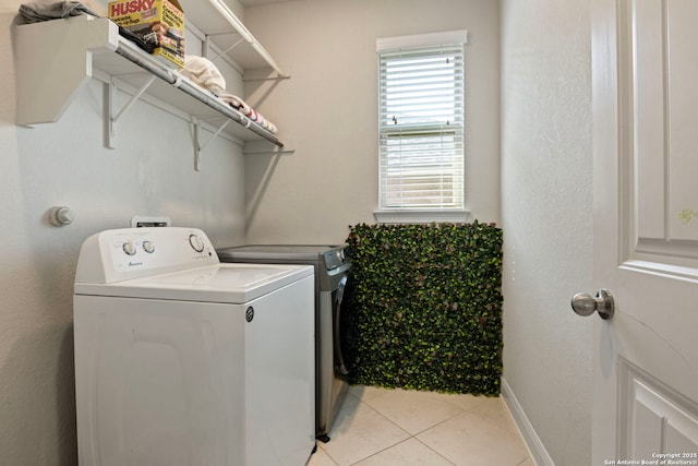 6239 Carriage Cpe, San Antonio, TX 78261 - laundry area with washer and dryer, light tile patterned floors, and baseboards