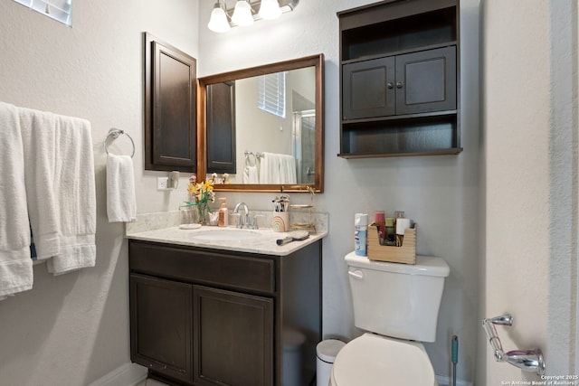 6239 Carriage Cpe, San Antonio, TX 78261 - full bathroom featuring vanity, toilet, and a shower with shower door