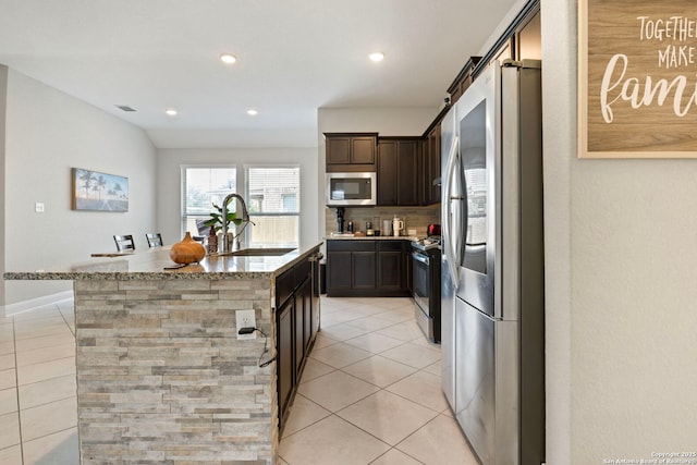 6239 Carriage Cpe, San Antonio, TX 78261 - kitchen with stainless steel appliances, a sink, light tile patterned floors, light stone countertops, and recessed lighting