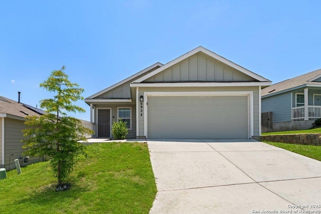 6624 Arid Way, San Antonio, TX 78252 - view of front facade featuring board and batten siding, a front yard, an attached garage, and concrete driveway