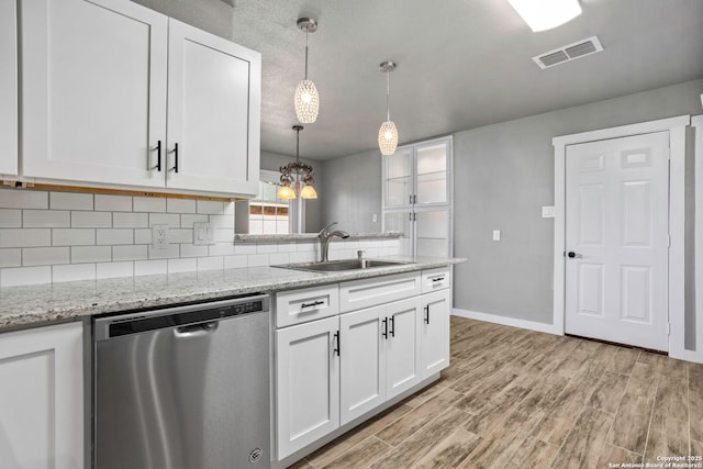 2723 Woodline, San Antonio, TX 78251 - kitchen with dishwasher, a sink, white cabinetry, and decorative backsplash