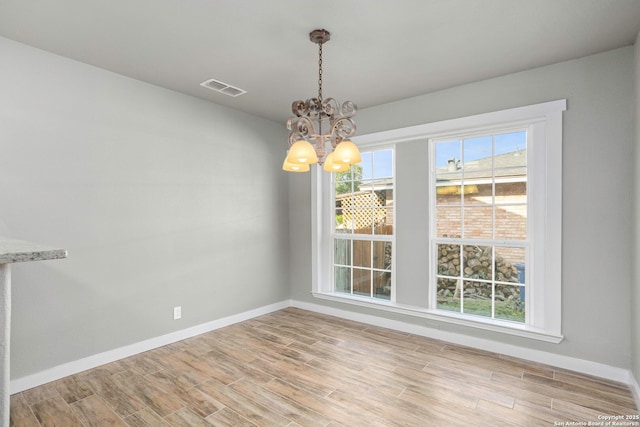 2723 Woodline, San Antonio, TX 78251 - spare room featuring a chandelier, light wood-style flooring, and baseboards