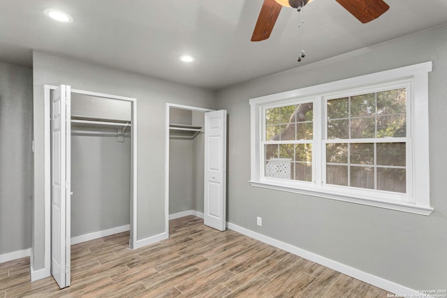 2723 Woodline, San Antonio, TX 78251 - unfurnished bedroom featuring two closets, wood finished floors, baseboards, and recessed lighting