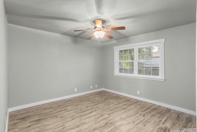 2723 Woodline, San Antonio, TX 78251 - empty room featuring wood finished floors, ceiling fan, baseboards, and a textured ceiling