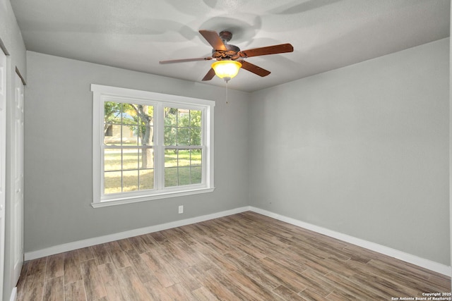 2723 Woodline, San Antonio, TX 78251 - spare room with wood finished floors, a ceiling fan, and baseboards