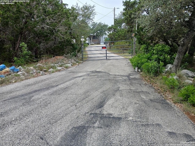 2362 Timbercreek, Pipe Creek, TX 78063 - view of asphalt road with a gate