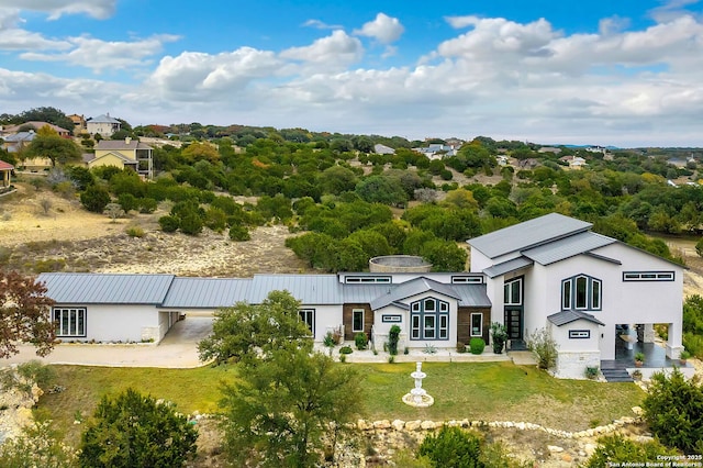 142 Wizard, Spring Branch, TX 78070 - back of property with a standing seam roof, stucco siding, metal roof, and a lawn