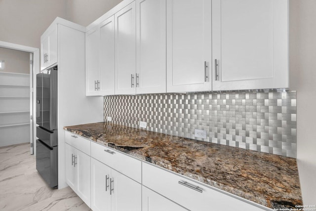 142 Wizard, Spring Branch, TX 78070 - kitchen with stainless steel fridge with ice dispenser, dark stone counters, light marble finish flooring, and decorative backsplash