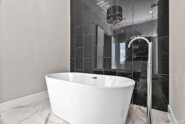 142 Wizard, Spring Branch, TX 78070 - bathroom with marble finish flooring, baseboards, a soaking tub, and a shower