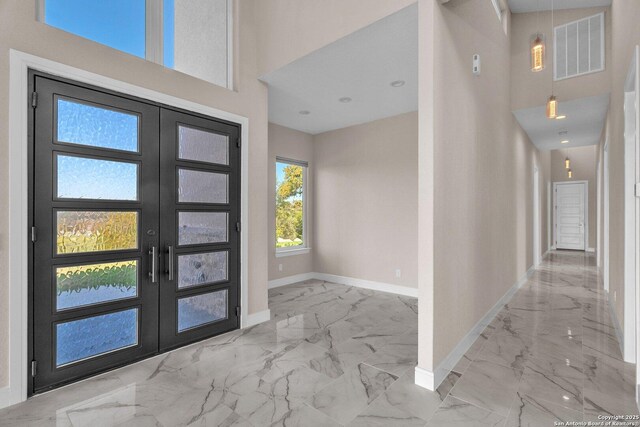142 Wizard, Spring Branch, TX 78070 - foyer featuring a high ceiling, baseboards, marble finish floors, and french doors