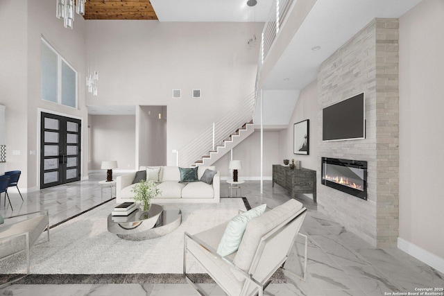 142 Wizard, Spring Branch, TX 78070 - living room featuring marble tiled floors, baseboards, a high ceiling, stairway, and a large fireplace