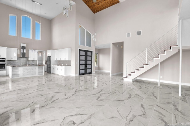 142 Wizard, Spring Branch, TX 78070 - unfurnished living room featuring high vaulted ceiling, light marble finish floors, baseboards, stairs, and wooden ceiling
