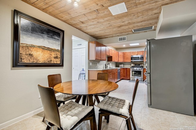 3811 E Songbird Ln, San Antonio, TX 78229 - dining room featuring wood ceiling, baseboards, and light tile patterned floors