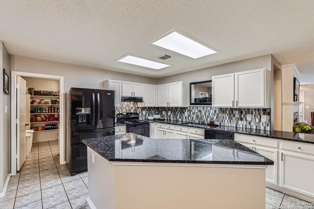 2334 Creekside Bnd, San Antonio, TX 78259 - kitchen with black appliances, decorative backsplash, white cabinets, dark stone counters, and a sink