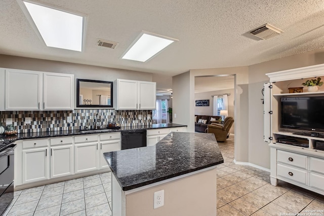 2334 Creekside Bnd, San Antonio, TX 78259 - kitchen with dishwasher, a sink, white cabinetry, decorative backsplash, and light tile patterned flooring