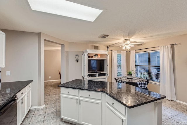 2334 Creekside Bnd, San Antonio, TX 78259 - kitchen with dishwasher, a center island, light tile patterned floors, white cabinets, and a ceiling fan