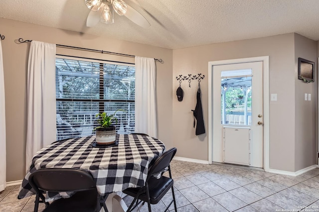 2334 Creekside Bnd, San Antonio, TX 78259 - dining area with baseboards, a textured ceiling, ceiling fan, and light tile patterned floors