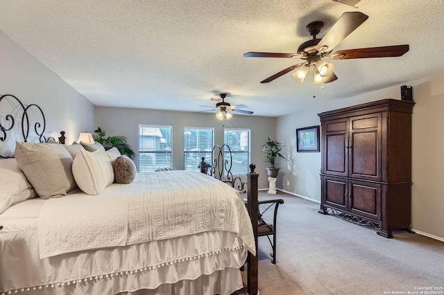 2334 Creekside Bnd, San Antonio, TX 78259 - bedroom with carpet, baseboards, a textured ceiling, and a ceiling fan