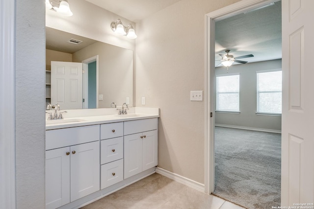 5614 Burr Blf, San Antonio, TX 78266 - bathroom featuring double vanity, baseboards, and ceiling fan
