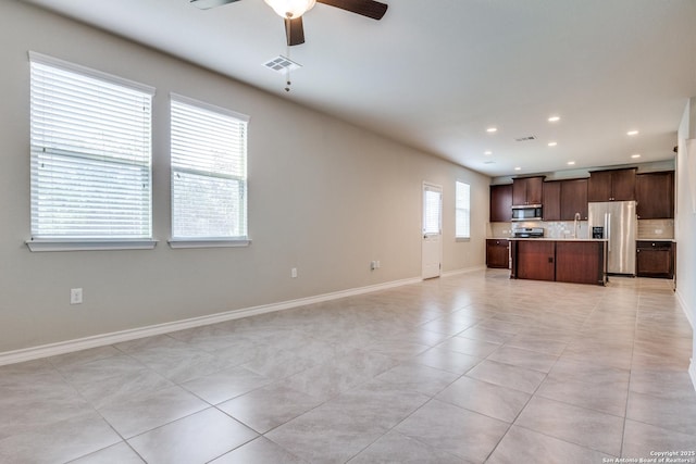 5614 Burr Blf, San Antonio, TX 78266 - unfurnished living room featuring a ceiling fan, light tile patterned floors, recessed lighting, and baseboards